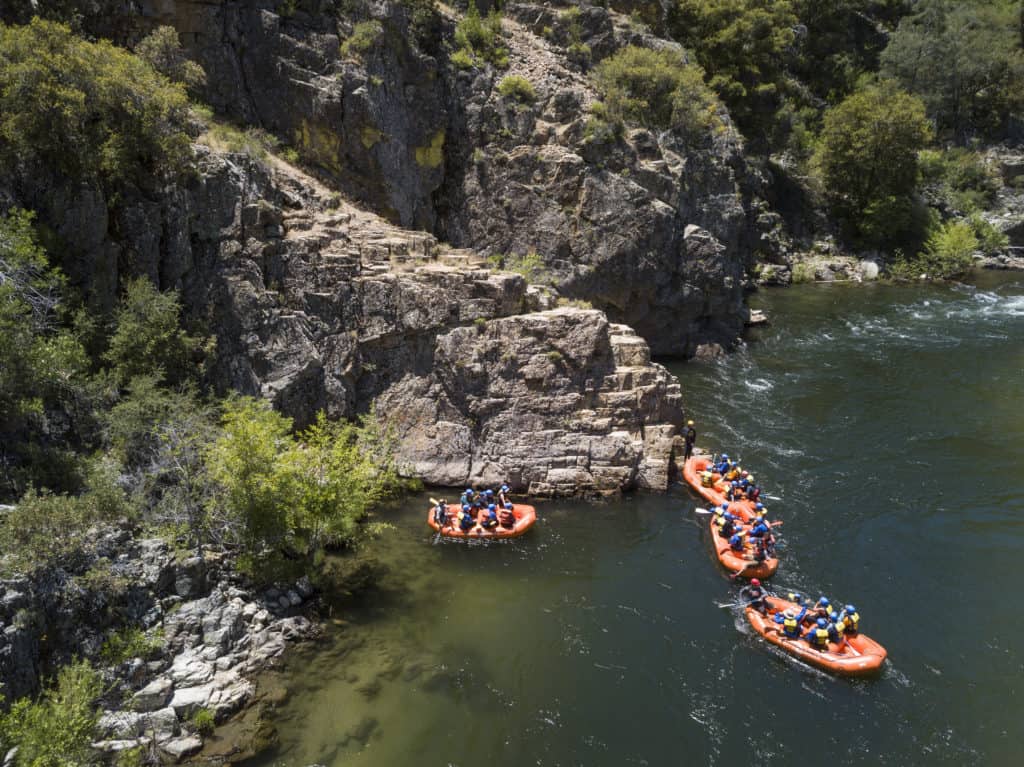 group of four rafts get ready to head down the river during their Lickety blaster adventure Sierra South Mountain Sports Kern River California