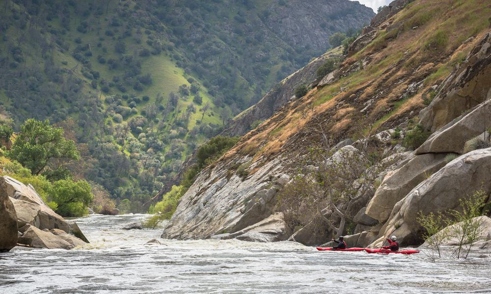 two kayakers take a break along the mountainside during their trip Sierra South Mountain Sports Kern River California