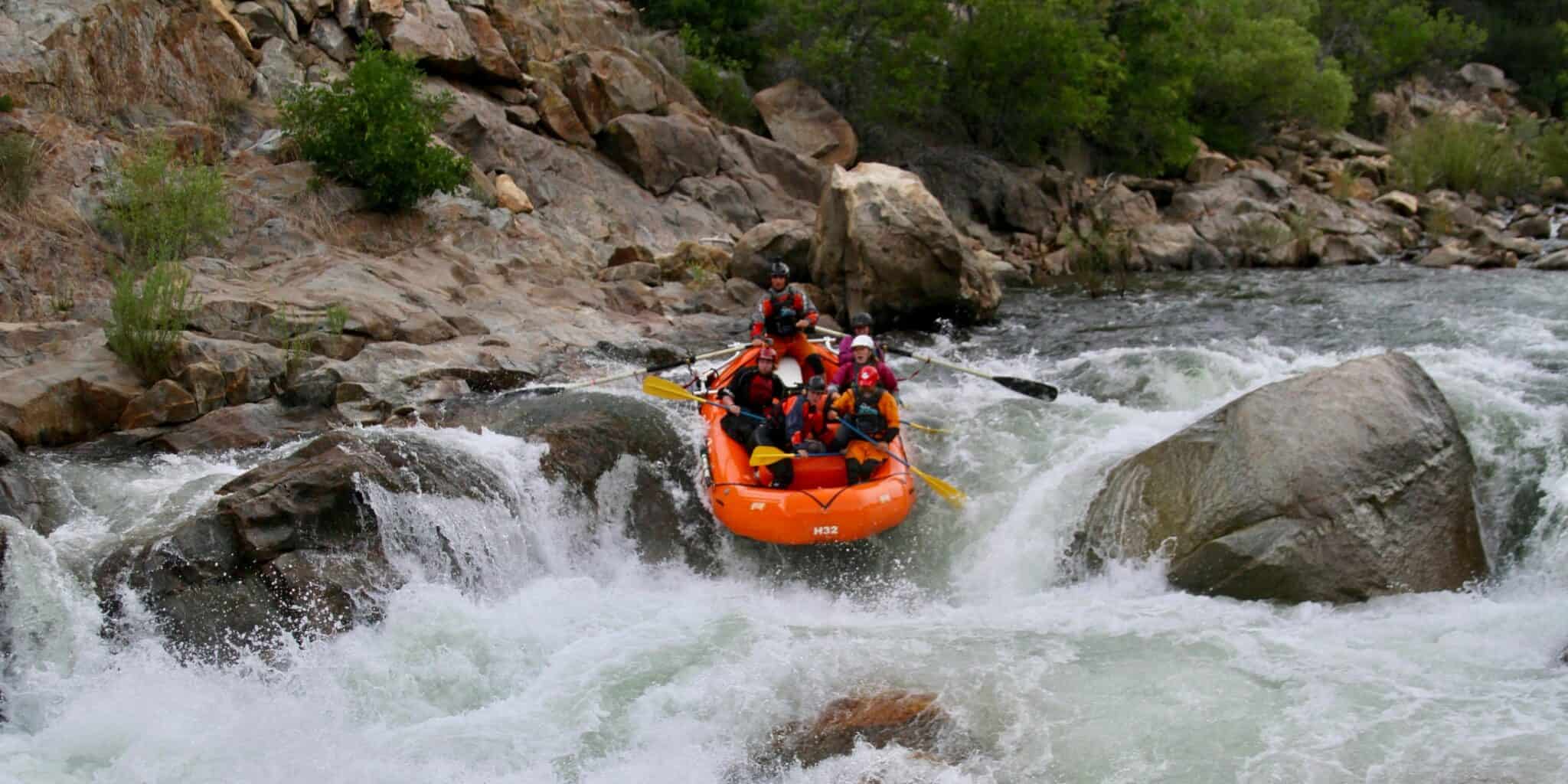 rafters enjoying the rapids through boulders Sierra South Mountain Sports Kern River California