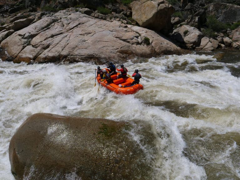 large boulders surround rafters as they navigate the river Sierra South Mountain Sports Kern River California