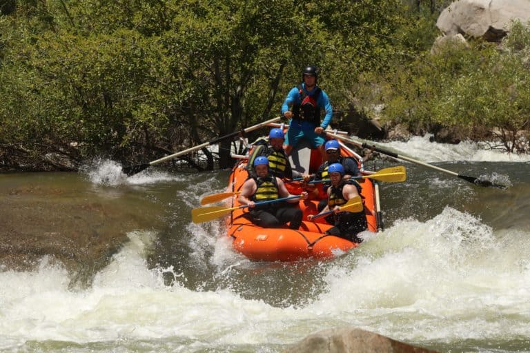 rafters and guide manage through strong whitewater rapids Sierra South Mountain Sports Kern River California